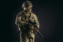 Portrait Of Serious Confident Brave Soldier In Army Wear, Camouflage, Isolated Over Black Background. Military Forces Concept