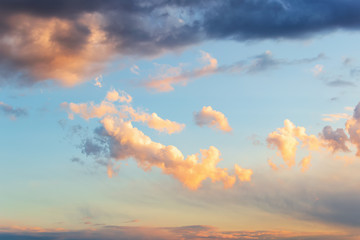 Wall Mural - beautiful golden cloud in a blue sky just before sunset. scenic sundown cloudscape for background. a