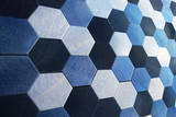 Fototapeta Do przedpokoju - Blue hexagons, there are a lot of figures, silver object