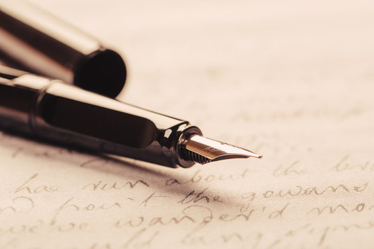 Fountain pen on an ancient handwritten letter. Old story. Retro style.