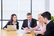 © Creativa Images - Multiethnic employees showing reports to the boss