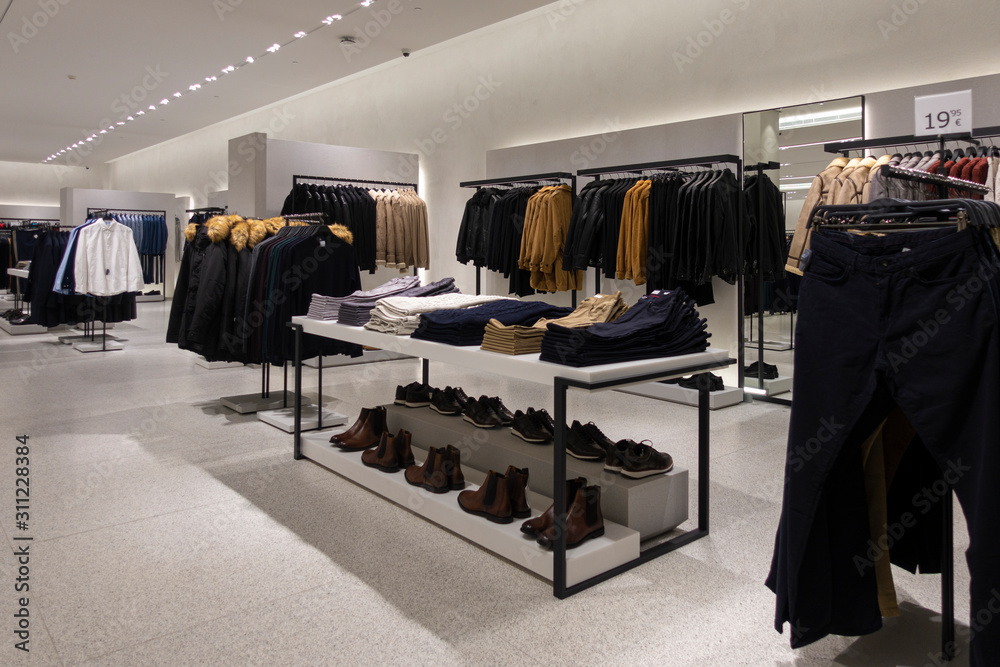 Modern fashionable brand interior of clothing store inside shopping center - obrazy, fototapety, plakaty 