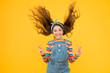 © be free - summer vacation joy. little child yellow background. old fashioned kid fashion. little beauty windy long hair. vintage style. happy childhood. retro girl cheerful gesture. hair fashion