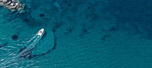 Aerial Drone Top View Photo Of Small Boat Cruising In Tropical Exotic Bay With Turquoise Sea