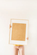 Blank Photo Frame With Empty Mockup Copy Space In Female Hands. Minimal Art Concept.