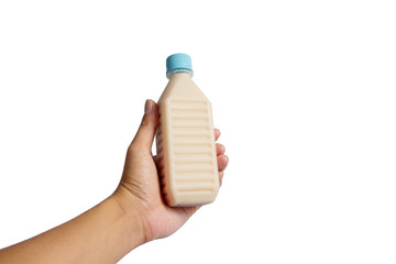 Hand holding plastic bottle Soy milk isolated on white background.