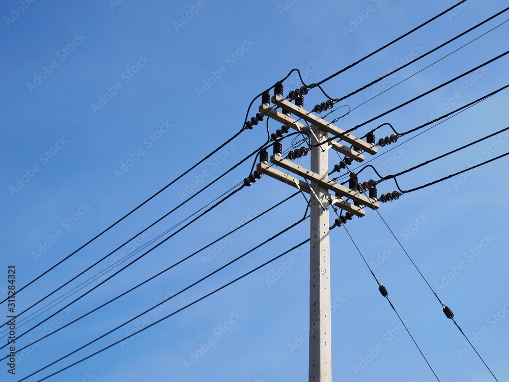 High voltage cable on the pole On the blue sky background With copy space - obrazy, fototapety, plakaty 