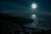 A Beautiful Full Moon Night On The Atlantic. The Place Is In The North Of Spain In Galicia And Is Called Cape Punta Nariga. The Moon Illuminates The Wild Sea And The Light Is Reflected From The Water.