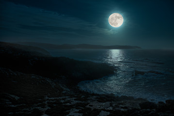 a beautiful full moon night on the atlantic. the place is in the north of spain in galicia and is ca