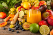 Healthy organic fresh multivitamin fruit juice with seasonal fruit decoration on rustic wooden table