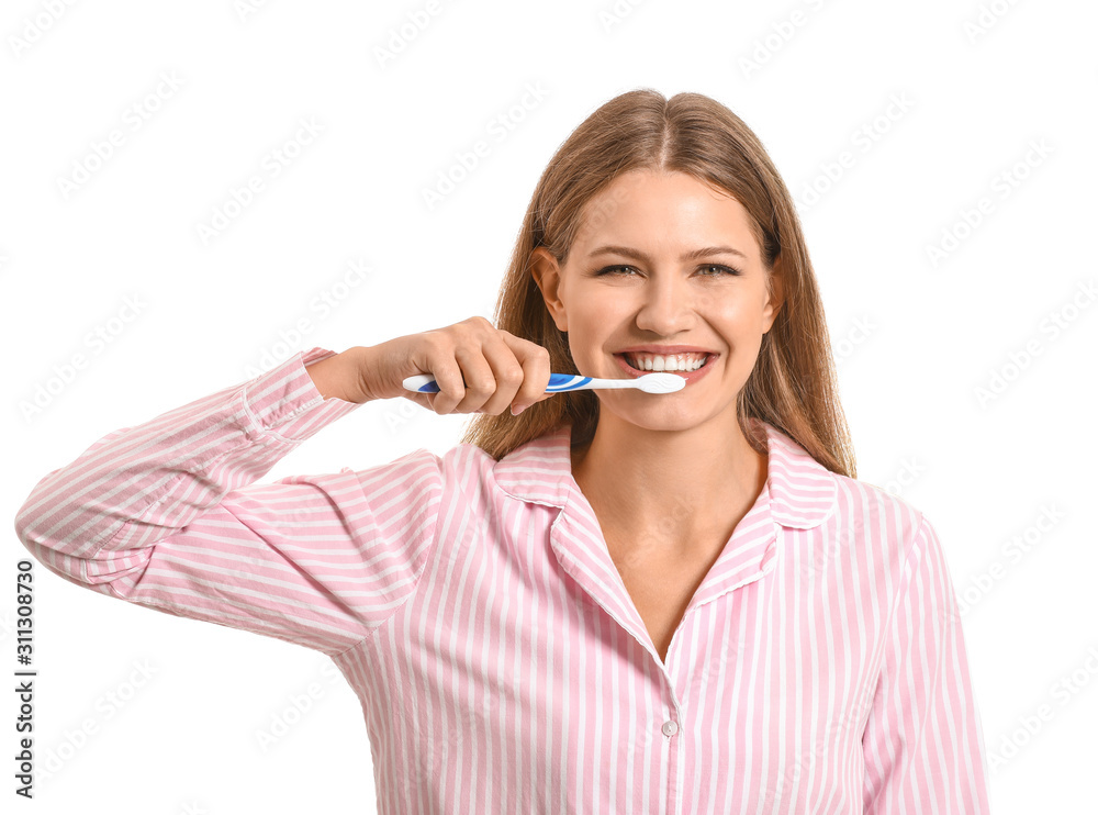 Young woman brushing teeth on white background