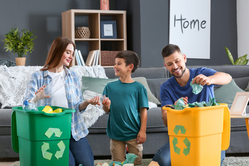 Family sorting garbage at home. Concept of recycling