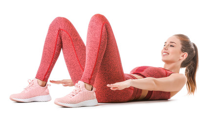 Wall Mural - Sporty young woman training against white background