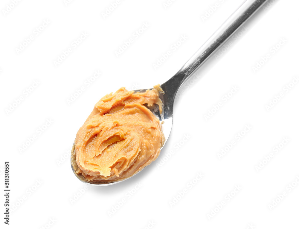 Spoon with tasty peanut butter on white background