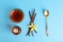 Flat Lay Composition With Vanilla Extract On Light Blue Background