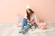 © Pixel-Shot - Young woman with funny husky puppy sitting near color wall