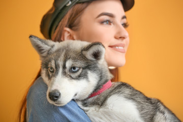 Sticker - Stylish woman with funny husky puppy on color background