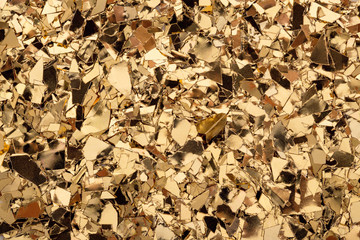 Wall Mural - gold glitter foil confetti background. festive, party or holiday backdrop. flat-lay, close-up.