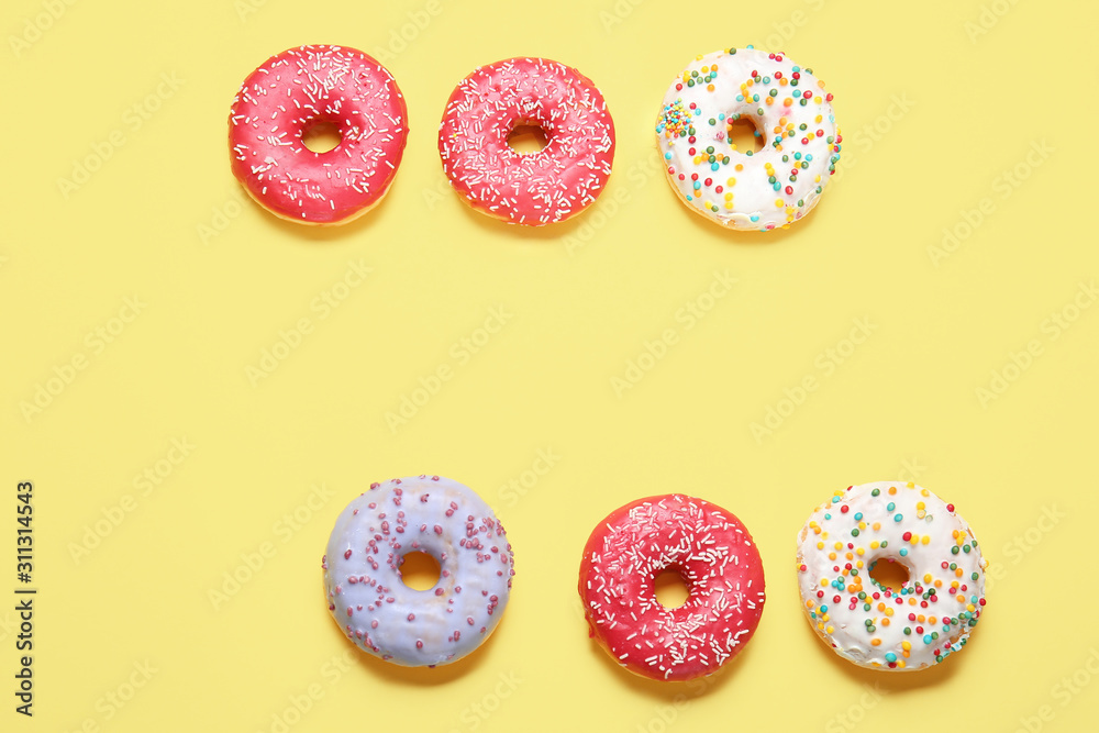Sweet tasty donuts on color background