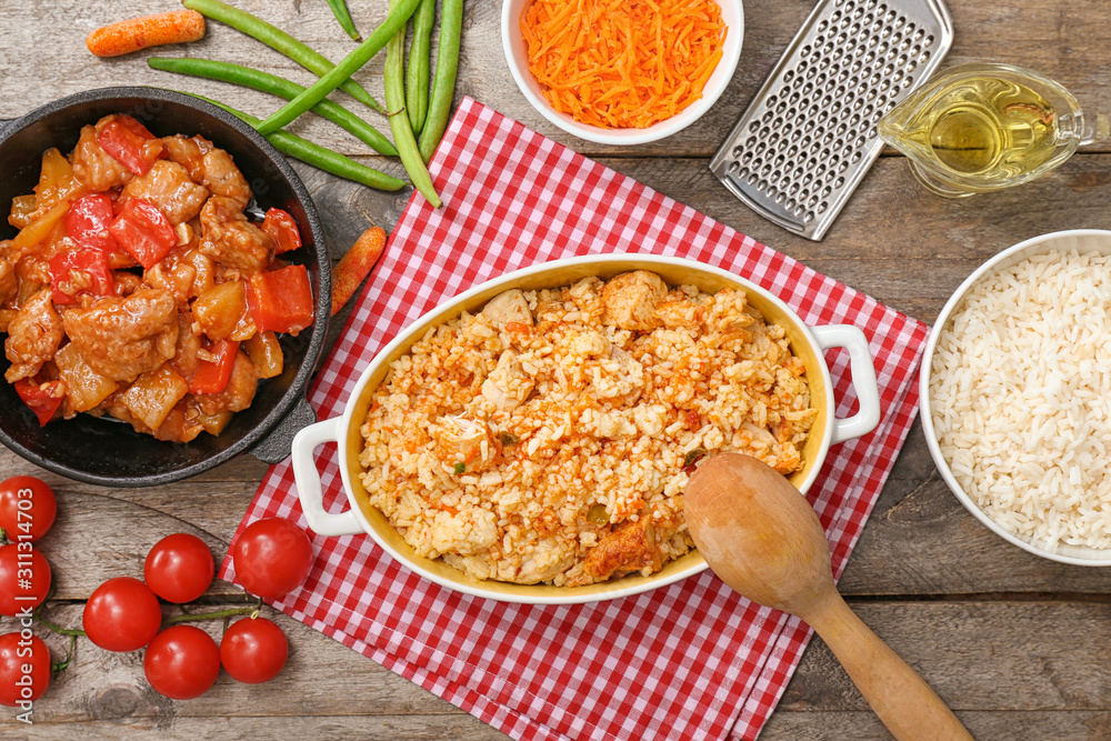 Dish with tasty rice on wooden table