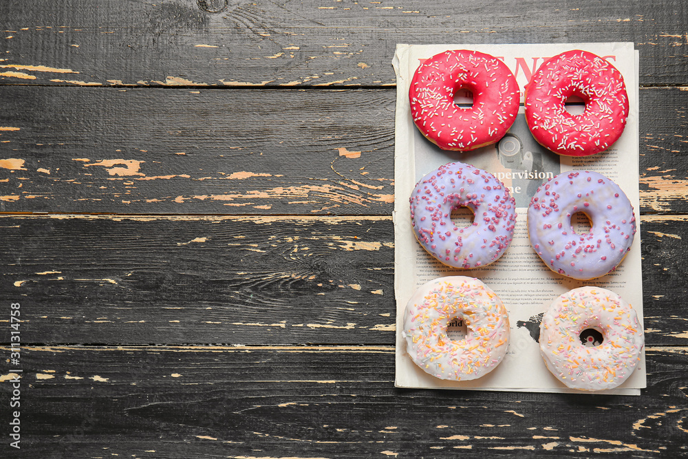 Sweet tasty donuts on table