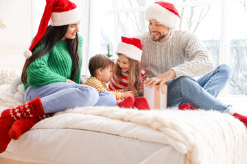 Wall Mural - Happy family with Christmas gift in bedroom