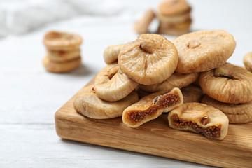 Tasty dried figs on white wooden table, closeup