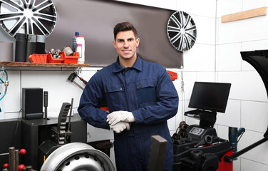 Wall Mural - Man near car disk lathe machine at tire service