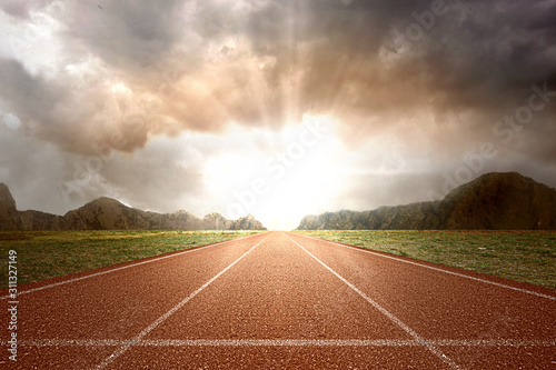 Fotografía Running track with green grass and mountain view