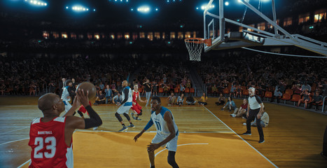 Basketball players on big professional arena during the game. Tense moment of the game. Celebration