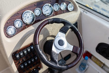 Modern Steering Wheel On Dashboard Background Of Luxury Pleasure Yacht, Gps Navigation, Clock, Compass, Sounder, Sonar, Driving Speed. Steering Wheel In Drops Of Rain And Water Motor Boat