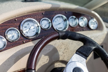 Modern Steering Wheel On Dashboard Background Of Luxury Pleasure Yacht, Gps Navigation, Clock, Compass, Sounder, Sonar, Driving Speed. Steering Wheel In Drops Of Rain And Water Motor Boat