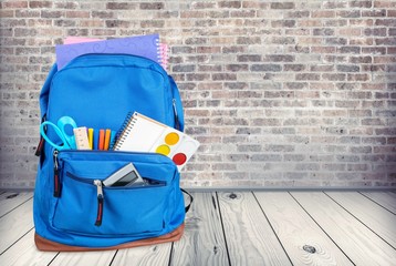 Canvas Print - Classic school backpack with colorful school supplies and books on desk.