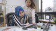 © PRPicturesProduction - chinese business woman with hand on shoulder of islam colleague. young muslim woman sick with painful abdominal sitting in modern office after lunch. multi ethnic workplace coworker care love.