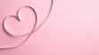 © photoguns - Heart shape border made of silver ribbon on pink background. Valentine's day greeting card mockup, minimal flat lay style composition with copy space. Love concept.