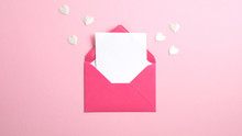 Envelope With Blank White Paper Note Inside And Valentine Hearts On Pink Background. Romantic Love Letter For Valentine's Or Mother's Day Concept.