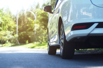 white car parking on road ,rear view of a car