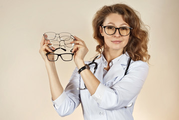 Poster - woman in white medical gown on yellow background. the doctor demonstrates a large selection of glass