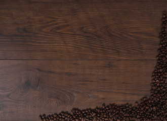 Coffee beans on brown wood background