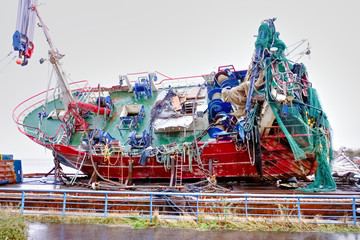 Wall Mural - Capsized ship vessel and rescue lift crane at port dock for repair of shipwreck