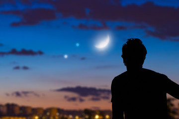 Wall Mural - man looking at the night sky from urban area.