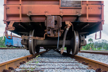 Rear View Of Rusty Train Car Sitting On Train Tracks. 