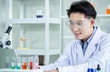© K-MookPan - concept of medical, chemicals or scientific laboratory research and Innovation in the laboratory. experienced handsome Asian man scientist is performing work in the laboratory.