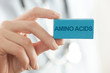© triocean - Doctor advises. Medical worker holds AMINO ACIDS signs.