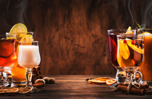 Selection Of Autumn Or Winter Seasonal Alcoholic Hot Cocktails - Mulled Wine, Glogg, Grog, Eggnog, Warm Ginger Ale, Hot Buttered Rum, Punch, Mulled Apple Cider On Wood Background, Copy S