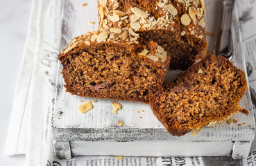 Wall Mural - Butter-free and sugar-free banana bread with almond on a light grey wooden tray. Ideas and recipes for healthy diet breakfast. Selective focus.