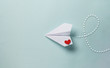 Leinwandbild Motiv paper love airplane on color background..The concept of a love message. Valentine's Day. Declare love. Love note.