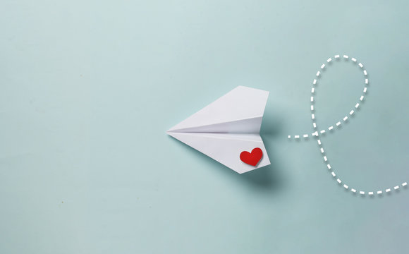 paper love airplane on color background..the concept of a love message. valentine's day. declare lov
