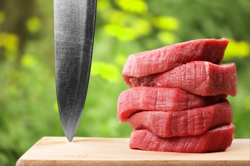 Wall Mural - Raw Meat slices and knife on cutting board