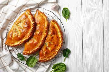 Wall Mural - freshly baked calzones with Spinach and Cheese